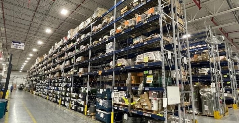 Metal shelves standing inside of an industrial warehouse