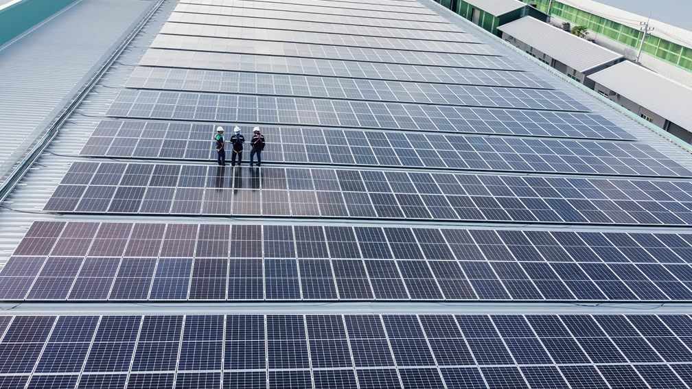 Construction workers standing on solar panels