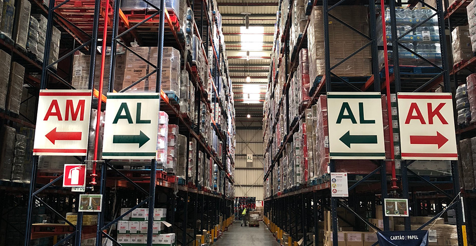 A warehouse with directional signs pointing left and right