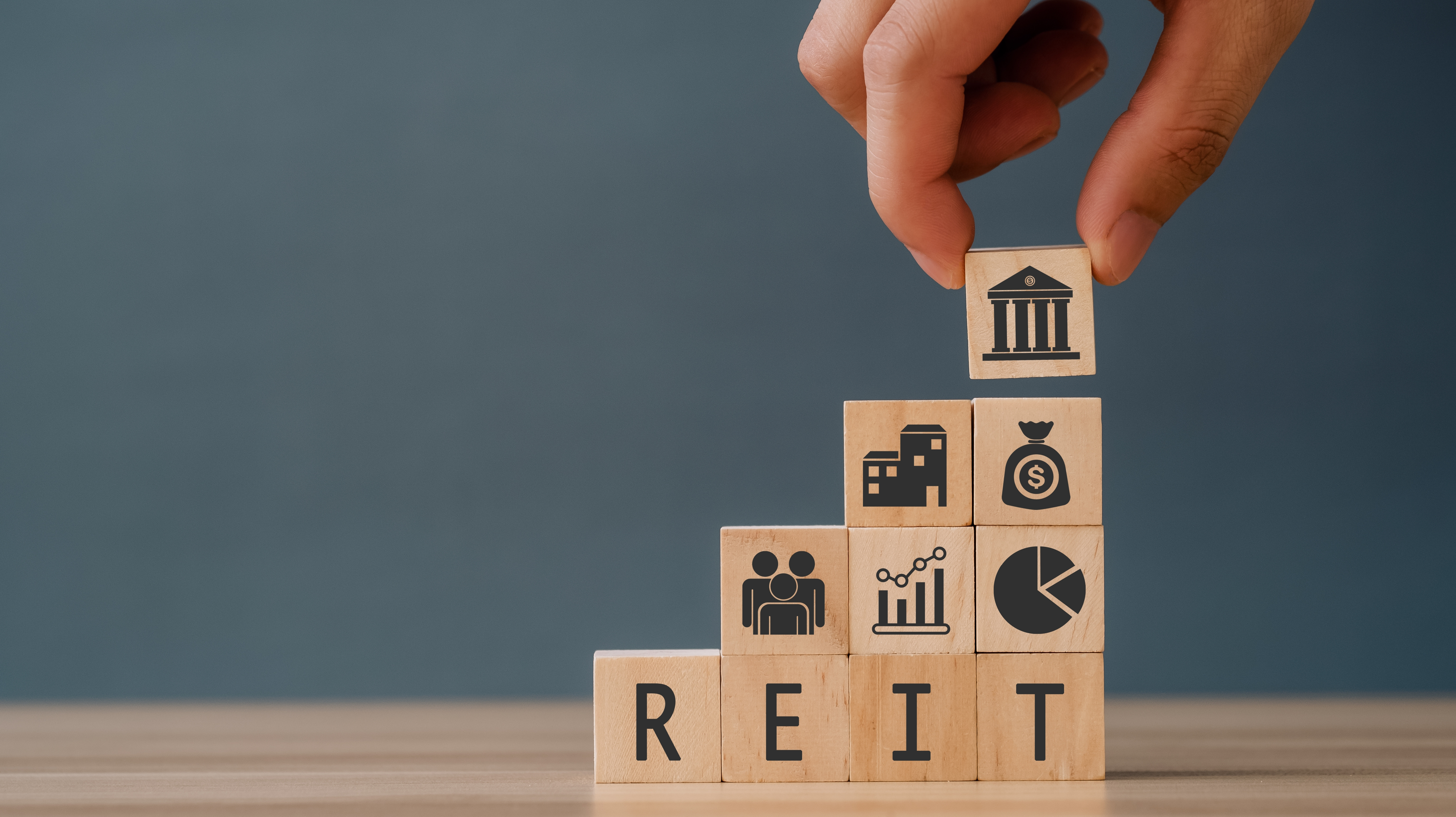 Photo of building blocks that spell REIT