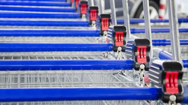 Shopping carts lined up with blue handles and red and black locks.