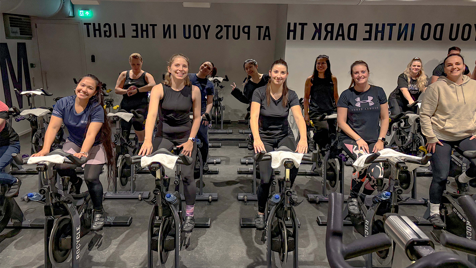 WPC Amsterdam employees on stationary bikes at the 2024 Health Fair.