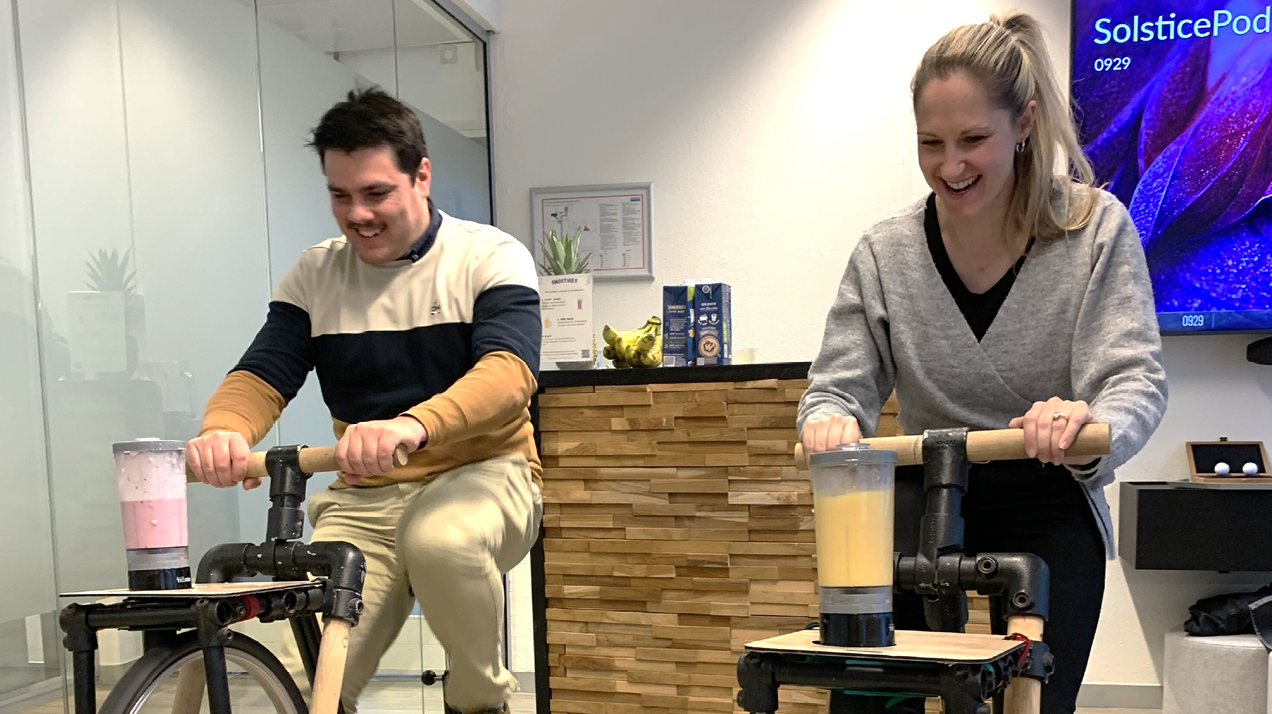 Two Amsterdam W. P. Carey employees on smoothie bikes during a recent Health Fair