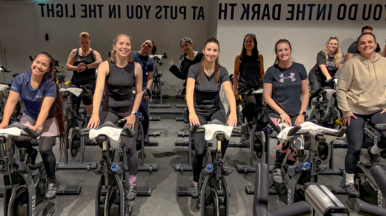 Amsterdam W. P. Carey employees on exercise bikes during a Health Fair activity.