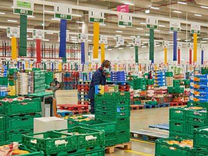 A retail warehouse with many items on a colorful array of shipping palets